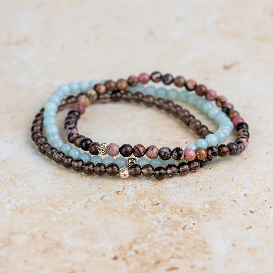 Rhodonite with Smoky Quartz and Amazonite are all combined to make the Essential Peace Crystal Bracelet Set 