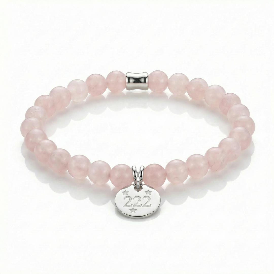 Pink beaded bracelet with a silver tag featuring the number 222 on a white background