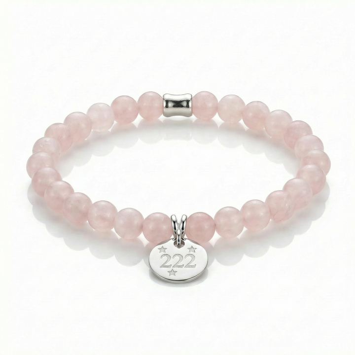 Pink beaded bracelet with a silver tag featuring the number 222 on a white background