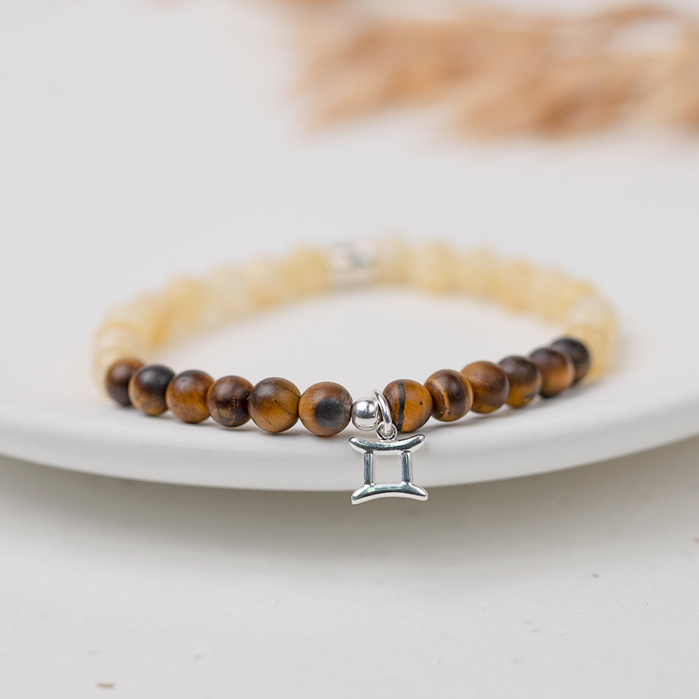Birthstone bracelet for a Gemini featuring a sterling silver charm and tiger's eye and yellow calcite gemstone beads